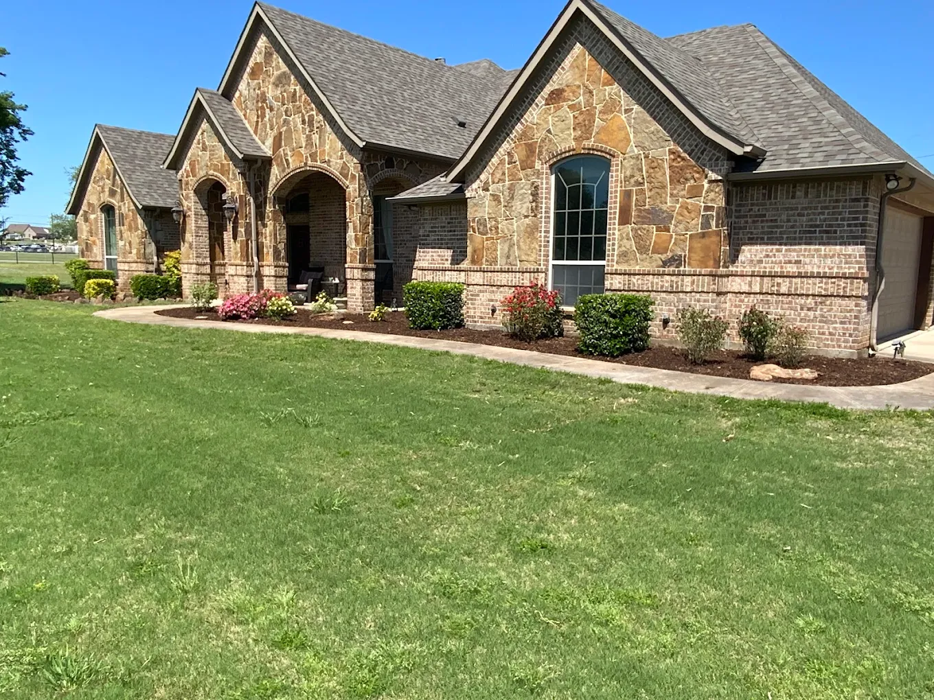 Freshly refreshed landscaping around a Fort Worth home